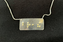 Load image into Gallery viewer, A functional, tactile braille necklace that reads "breathe" in grade 2 braille. The piece is polished silver with gold dots.