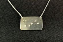 Load image into Gallery viewer, A functional, tactile braille necklace that reads "shine" in grade 2 braille. The piece is bright, polished silver.