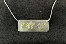 Load image into Gallery viewer, A functional, tactile braille necklace that reads "persist" in grade 2 braille. The piece is bright, polished silver with gold dots.
