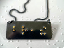 Load image into Gallery viewer, A functional, tactile braille necklace that reads "breathe" in grade 2 braille. The piece is dark, oxidized silver with gold dots,