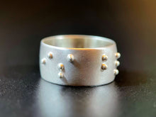 Load image into Gallery viewer, A sterling silver ring with the words "is blind" in accurate, functional, grade 2 braille.