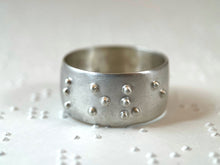 Load image into Gallery viewer, A sterling silver ring, with the word "love" visible in accurate, functional, grade 2 braille.