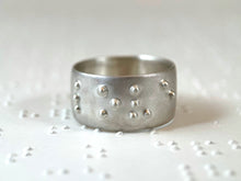 Load image into Gallery viewer, A sterling silver ring that reads "love" in accurate, functional braille.