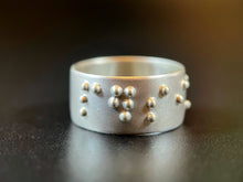 Load image into Gallery viewer, A sterling silver ring reading "persist" in accurate, functional, grade 2 braille.