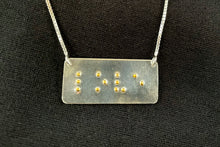 Load image into Gallery viewer, A functional, tactile braille necklace that reads &quot;love&quot; in grade 2 braille. The piece is bright, polished silver with gold dots.
