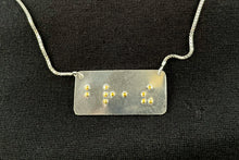 Load image into Gallery viewer, A functional, tactile braille necklace that reads &quot;breathe&quot; in grade 2 braille. The piece is polished silver with gold dots.
