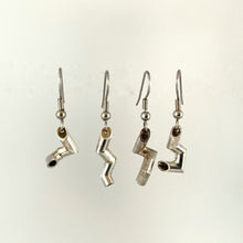 Load image into Gallery viewer, Four earrings hanging side by side. Each is made of sterling silver tubing bent at sharp angles into an interesting shape. No two are the same.
