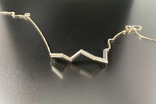 Load image into Gallery viewer, A necklace of sterling silver tubing, in a zigzag shape.
