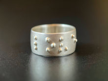Load image into Gallery viewer, A sterling silver ring that reads &quot;love&quot; in accurate, functional braille.
