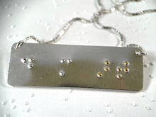 Load image into Gallery viewer, A functional, tactile braille necklace that reads &quot;do more art&quot; in grade 2 braille. The word &#39;art&#39; is done in gold.
