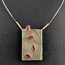 Load image into Gallery viewer, A rectangular pendant, taller than it is wide. On the right side is some wire suggesting the trunk and branches of a tree. There are 4 marquise-cut rubies arranged like falling leaves down the piece. 
