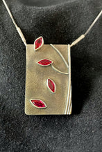 Load image into Gallery viewer, A rectangular pendant, taller than it is wide. On the right side is some wire suggesting the trunk and branches of a tree. There are 4 marquise-cut rubies arranged like falling leaves down the piece. 
