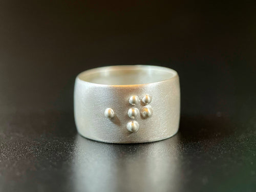 A sterling silver ring reading 