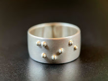 Load image into Gallery viewer, A sterling silver ring reading &quot;shine&quot; in accurate, functional, grade 2 braille.
